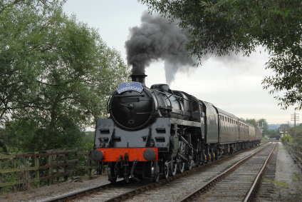 Classic british steam train pulling passenger carriages